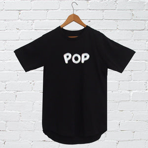 I'm With The Band® Bubble Pop T-shirt with iridescent white print on black T on a coat hanger against a white painted brick wall