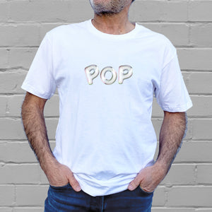 I'm With The Band® Bubble Pop T-shirt with iridescent print on white T being worn by a faceless man standing against a white painted brick wall