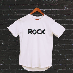 I'm With The Band® Bubble Rock T-shirt with black print on white T on a coat hanger against a white painted brick wall