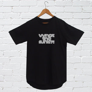 I'm With The Band® What The Funk? T-shirt with white print on black T on a coat hanger against a white painted brick wall